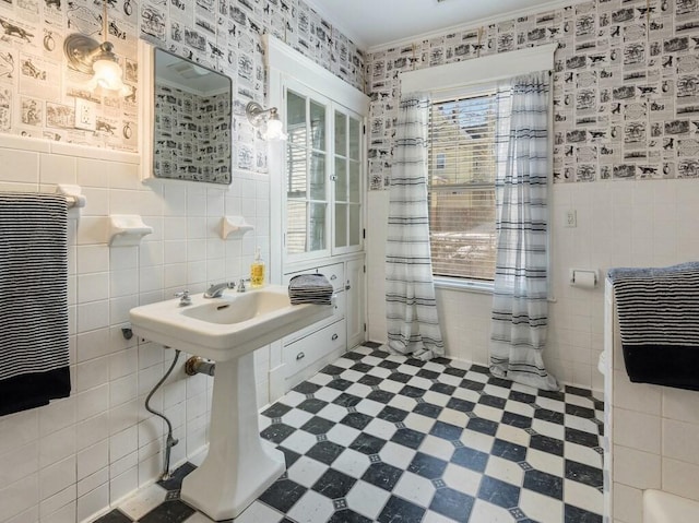 bathroom with crown molding and tile walls