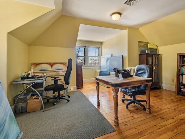 office area featuring lofted ceiling and light hardwood / wood-style floors