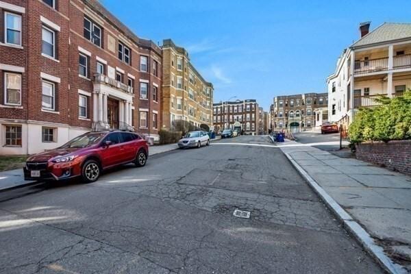 view of asphalt road with sidewalks and curbs