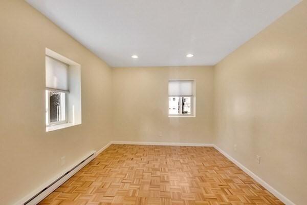 spare room with a baseboard heating unit, baseboards, and recessed lighting