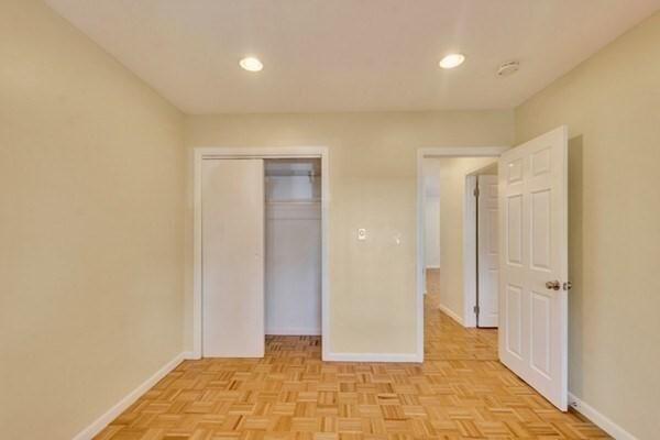 unfurnished bedroom with baseboards, recessed lighting, and a closet