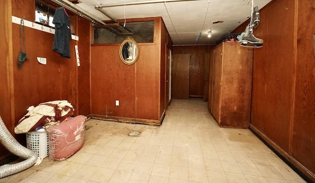 interior space with light floors and wooden walls