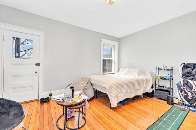 bedroom featuring wood finished floors and baseboards