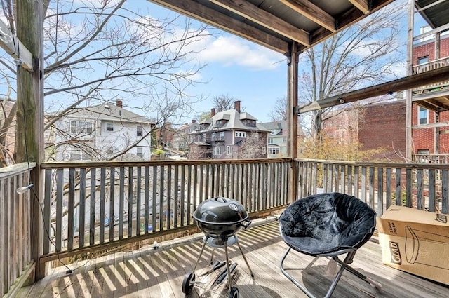 wooden terrace featuring a residential view and grilling area