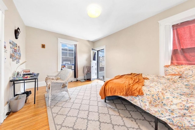 bedroom with light wood finished floors and baseboards