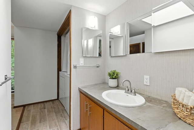 611 Old Stone Brk Unit 611, Acton, MA 01718 - bathroom with vanity, wood finished floors, and washer / clothes dryer