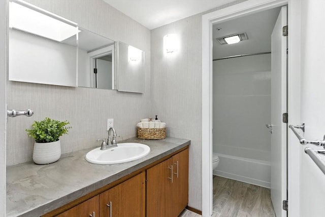 611 Old Stone Brk Unit 611, Acton, MA 01718 - bathroom featuring vanity, wood finished floors, backsplash, and shower / bath combination