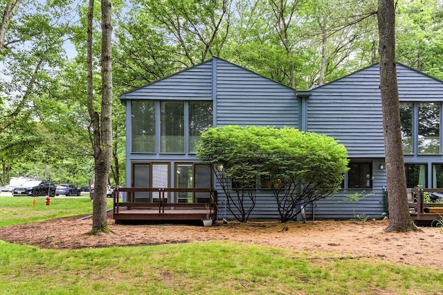611 Old Stone Brk Unit 611, Acton, MA 01718 - back of house featuring a wooden deck, a yard, and a sunroom