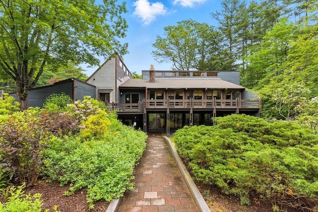 611 Old Stone Brk Unit 611, Acton, MA 01718 - back of house with a wooden deck and a chimney