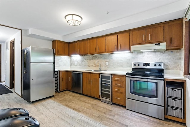 611 Old Stone Brk Unit 611, Acton, MA 01718 - kitchen featuring stainless steel appliances, beverage cooler, under cabinet range hood, and brown cabinetry