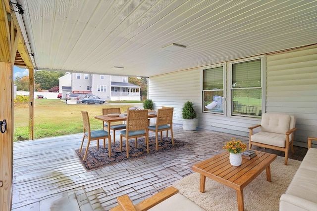 wooden terrace featuring a yard and a patio