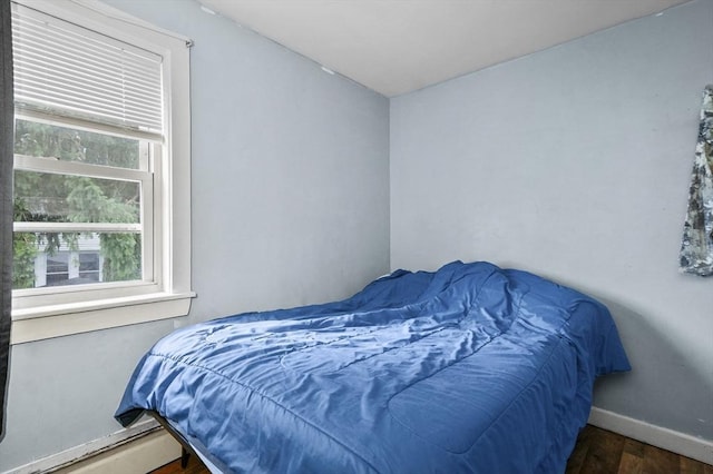 18 Cedar Ct, Lowell, MA 01852 - bedroom featuring baseboard heating, wood finished floors, and baseboards