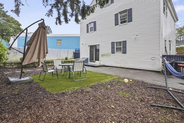 18 Cedar Ct, Lowell, MA 01852 - rear view of house with a patio