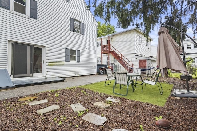 18 Cedar Ct, Lowell, MA 01852 - back of house with a patio and a lawn