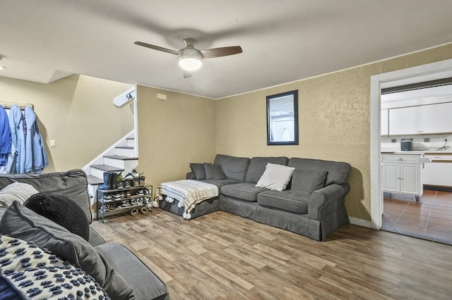 18 Cedar Ct, Lowell, MA 01852 - living room featuring wood finished floors, a textured wall, a ceiling fan, and stairs