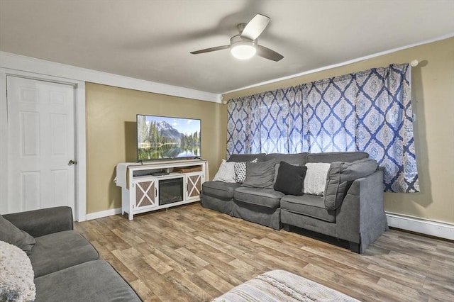18 Cedar Ct, Lowell, MA 01852 - living room with ornamental molding, ceiling fan, a baseboard heating unit, wood finished floors, and baseboards