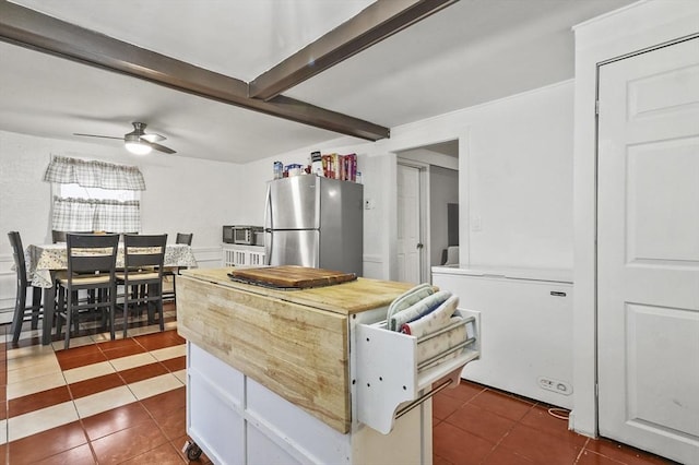 18 Cedar Ct, Lowell, MA 01852 - kitchen featuring freestanding refrigerator, dark tile patterned flooring, fridge, ceiling fan, and beamed ceiling