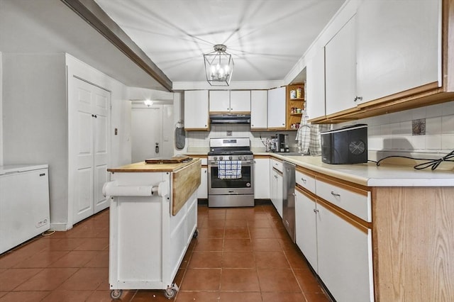 18 Cedar Ct, Lowell, MA 01852 - kitchen featuring stainless steel appliances, under cabinet range hood, decorative backsplash, white cabinetry, and a sink