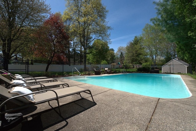 view of pool with a fenced in pool, a patio area, and fence