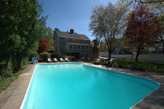view of swimming pool with a fenced in pool and fence