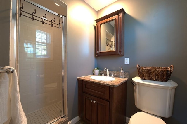 full bath featuring vanity, toilet, and a stall shower