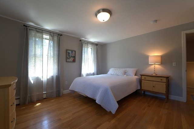 bedroom featuring baseboards and wood finished floors