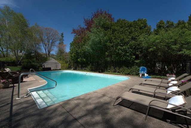 pool with fence and a patio area