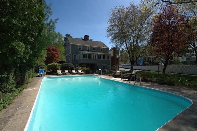 view of pool with a fenced in pool and fence