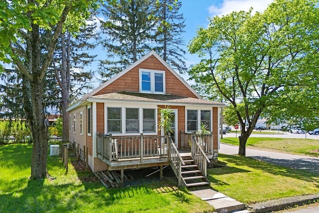 206 Pleasant St, North Andover, MA 01845 - view of front of property with a front yard, central AC unit, and a deck