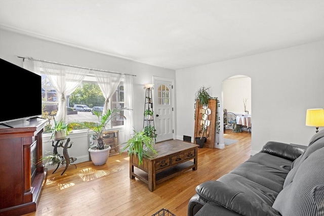 206 Pleasant St, North Andover, MA 01845 - living area with arched walkways and light wood-type flooring