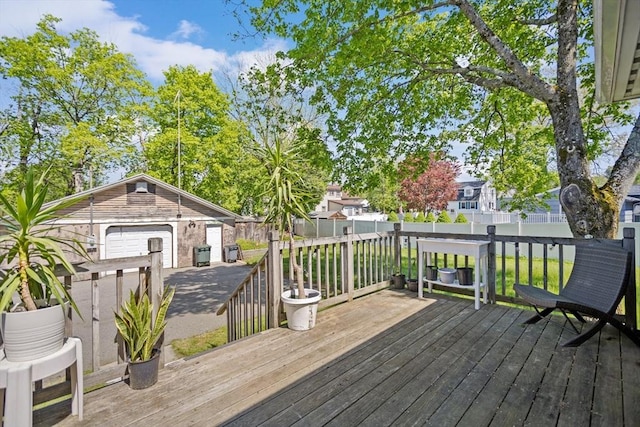 206 Pleasant St, North Andover, MA 01845 - deck featuring a detached garage, a fenced backyard, and an outbuilding