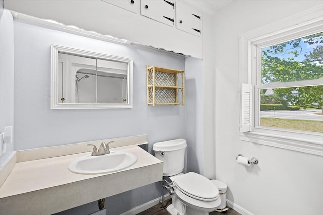 206 Pleasant St, North Andover, MA 01845 - bathroom featuring a sink, toilet, and baseboards
