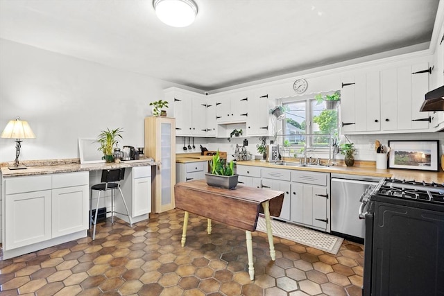 206 Pleasant St, North Andover, MA 01845 - kitchen with gas stove, light countertops, white cabinetry, and stainless steel dishwasher