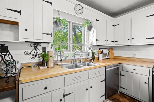 206 Pleasant St, North Andover, MA 01845 - kitchen featuring dishwasher, a sink, backsplash, and white cabinets