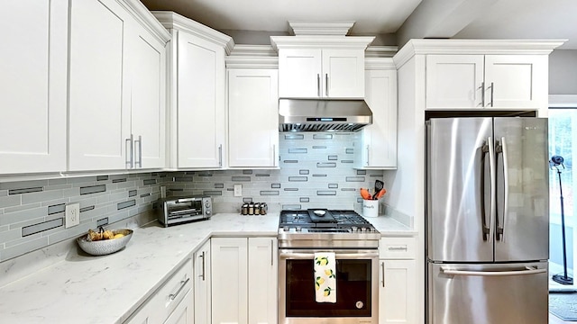 kitchen with white cabinetry, stainless steel appliances, and range hood