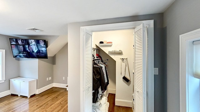 walk in closet featuring light hardwood / wood-style flooring