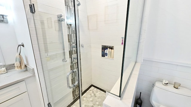 bathroom with walk in shower, tile walls, and toilet