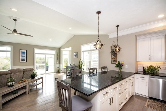 29 Spyglass Ln, Plymouth, MA 02360 - kitchen featuring open floor plan, stainless steel dishwasher, a peninsula, plenty of natural light, and vaulted ceiling