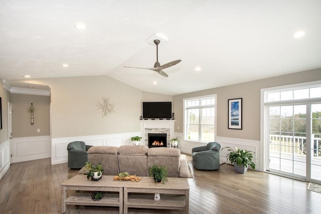 29 Spyglass Ln, Plymouth, MA 02360 - living room with a wainscoted wall, hardwood / wood-style flooring, a lit fireplace, a ceiling fan, and vaulted ceiling