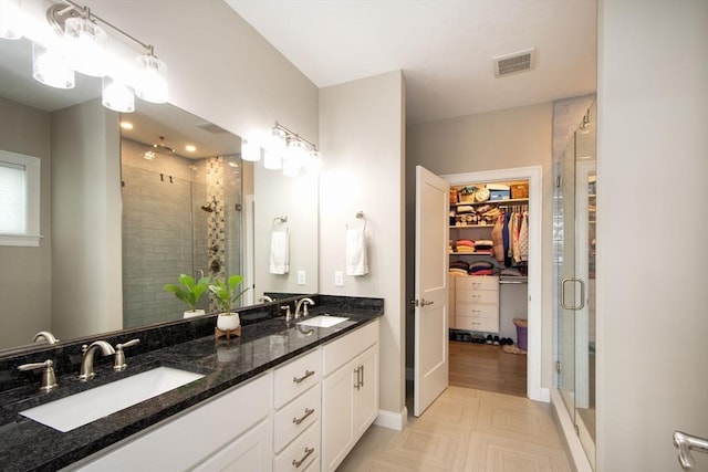 29 Spyglass Ln, Plymouth, MA 02360 - bathroom with a shower stall, a walk in closet, and double vanity