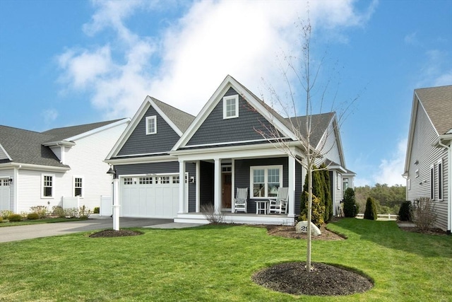29 Spyglass Ln, Plymouth, MA 02360 - view of front of house with covered porch, driveway, a front yard, and an attached garage
