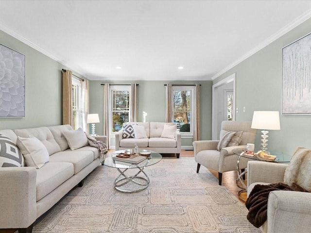 living room with ornamental molding and light hardwood / wood-style floors