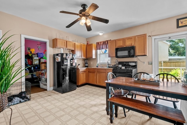 kitchen with ceiling fan, a wealth of natural light, and black appliances