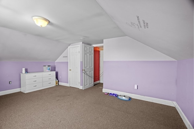 additional living space featuring carpet floors and vaulted ceiling