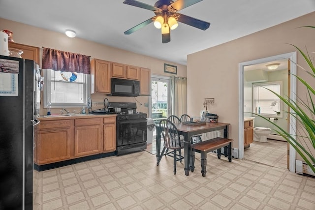 kitchen with black appliances, ceiling fan, and sink