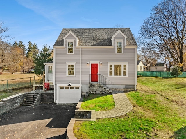 view of front facade featuring a front lawn and a garage