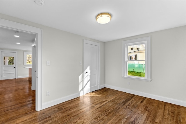 spare room with wood-type flooring