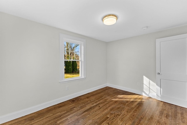 unfurnished room with hardwood / wood-style floors