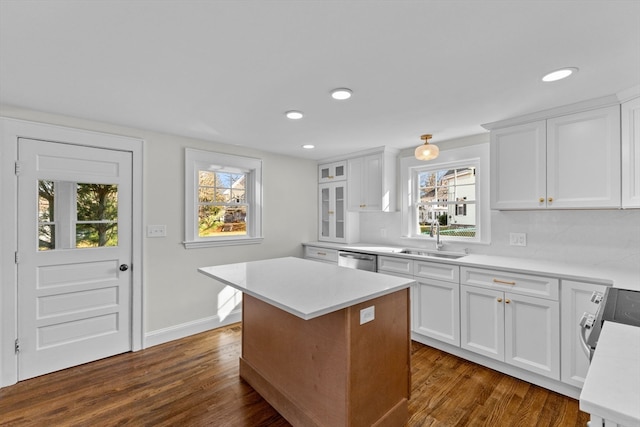 kitchen with dark hardwood / wood-style floors, white cabinetry, a healthy amount of sunlight, and sink