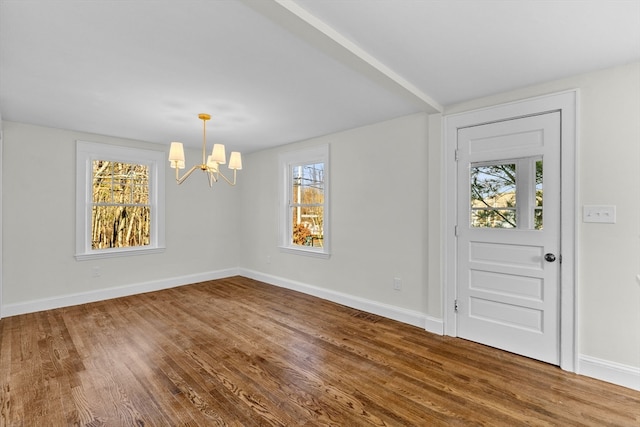 foyer with wood-type flooring and an inviting chandelier